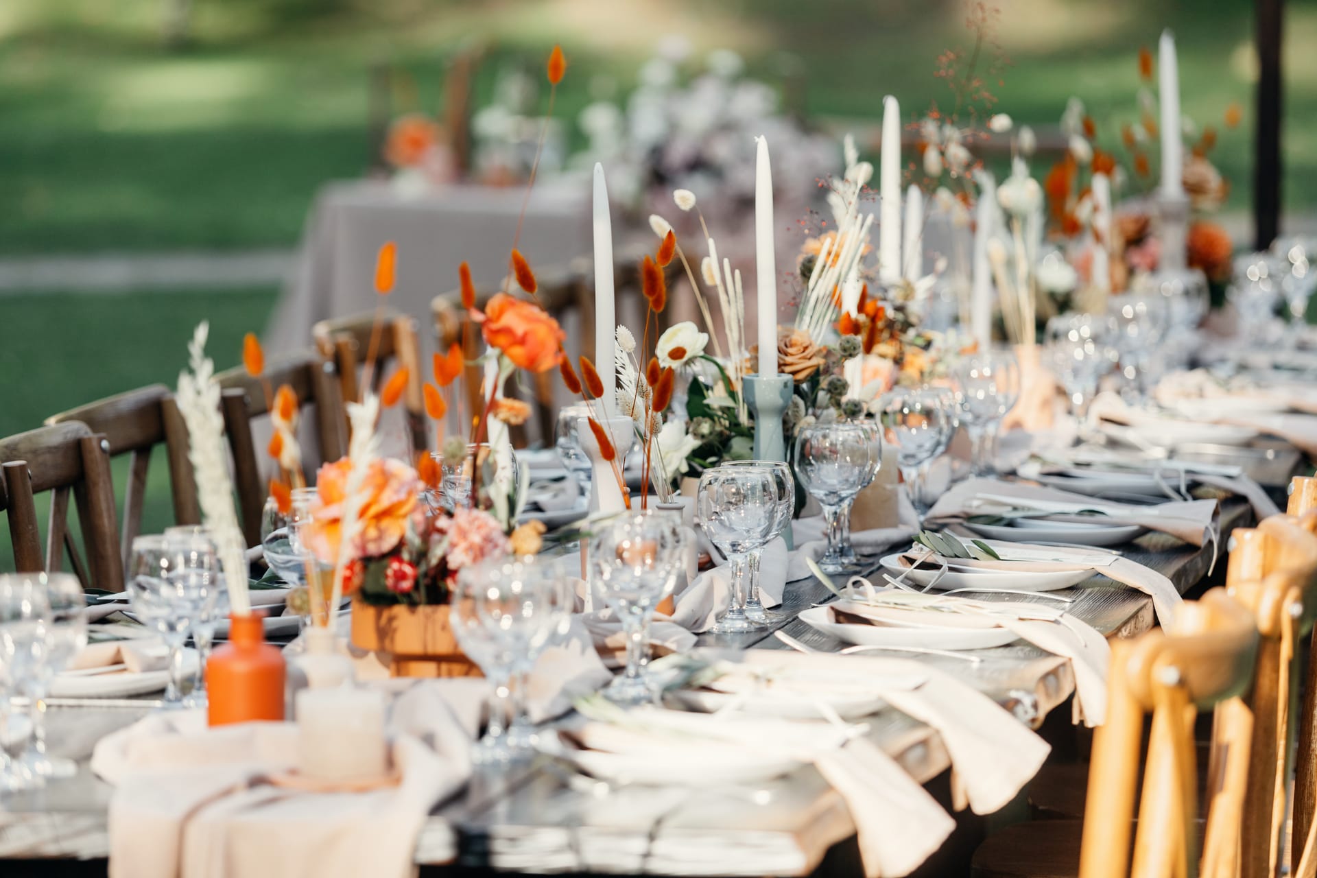 Long wedding reception table set with candles and flowers